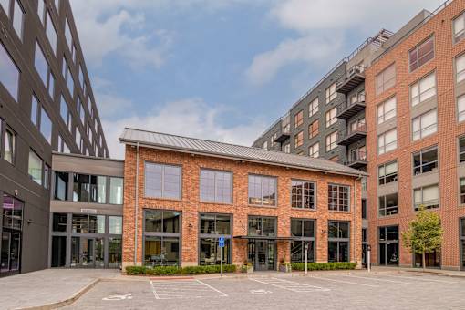 a large brick building with a courtyard in front of it at The Audubon New Haven, New Haven, CT, 06511