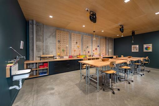 a dining room with tables and chairs and a wall with magnets on it at The Audubon New Haven, New Haven, CT, 06511