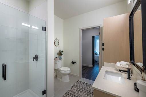 a bathroom with a shower toilet and sink at The Audubon New Haven, New Haven