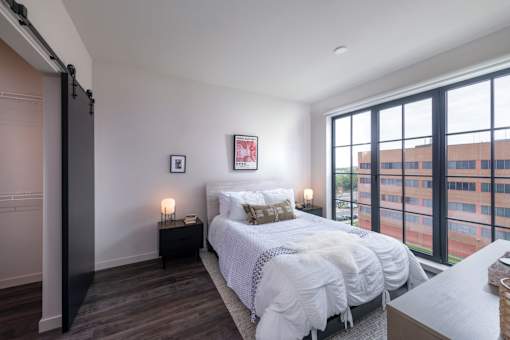 a bedroom with a bed and a large window at The Audubon New Haven, New Haven, CT, 06511