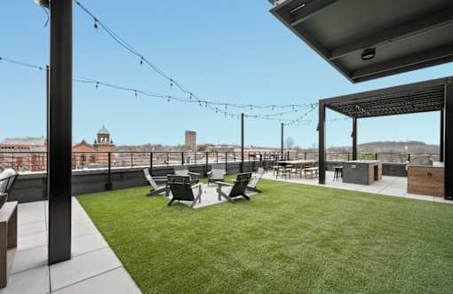 the roof terrace of a building with a lawn and chairs at The Audubon New Haven, New Haven, Connecticut