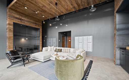 a living room with grey walls and a white couch and a table at The Audubon New Haven, New Haven, 06511