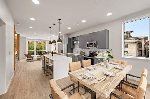 a kitchen and dining room with a table and chairs at The Audubon New Haven, New Haven, CT