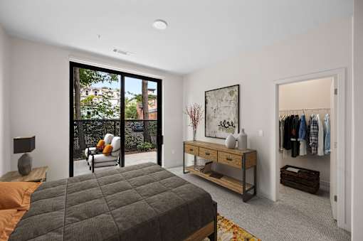 a bedroom with a bed and a closet with a dresser at The Audubon New Haven, New Haven, Connecticut