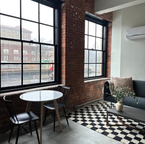 a small room with a table and chairs and a window