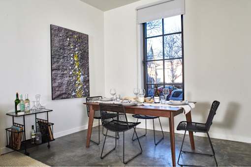 a dining room with a table and chairs and a window at The Audubon New Haven, Connecticut, 06511