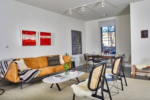 a living room with a couch and chairs and a dining room table at The Audubon New Haven, Connecticut, 06511