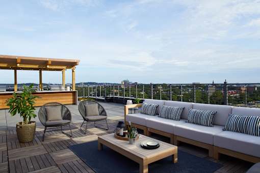 a rendering of a balcony with a couch and chairs at The Audubon New Haven, Connecticut