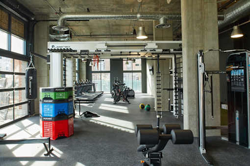 a workout room with weights and other gym equipment at The Audubon New Haven, New Haven
