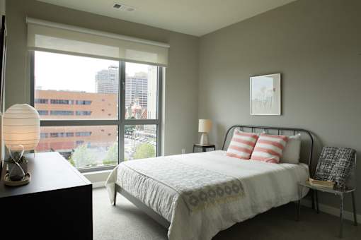 a bedroom with a bed and a large window at The Audubon New Haven, Connecticut, 06511