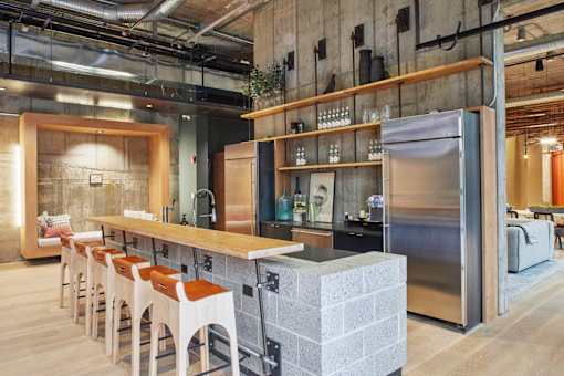 a kitchen with a counter and chairs in a restaurant at The Audubon New Haven, New Haven, Connecticut