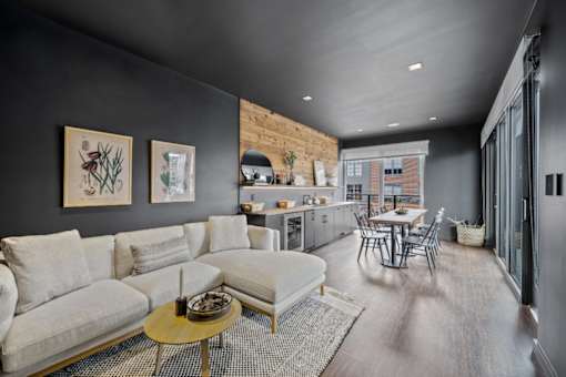A modern living room with a grey couch and a coffee table.