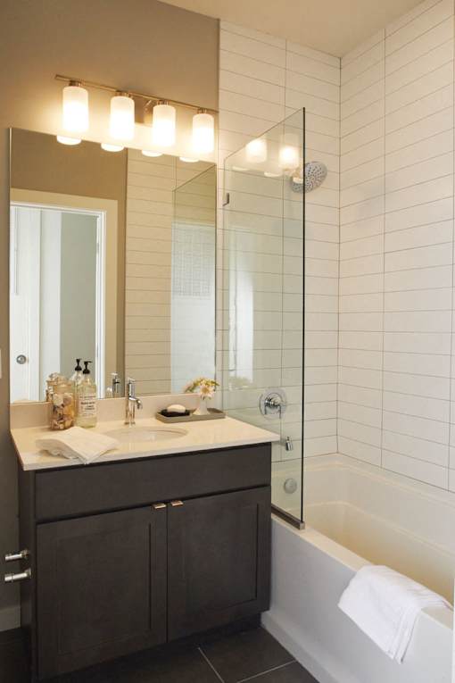 A bathroom with a white sink and a mirror above it.