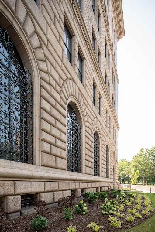 A large building with a lot of windows and a garden in front. at The 55 Elm Club, Hartford