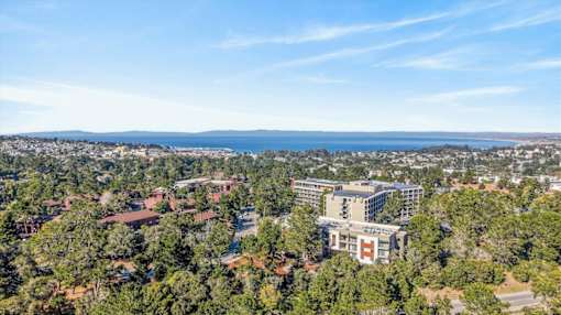 A bird's eye view of a residential area with a large building in the center.
