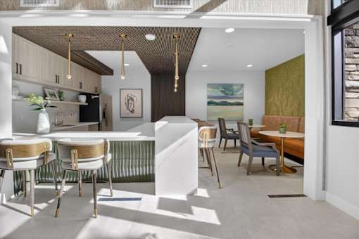 A modern kitchen with a dining table and chairs.