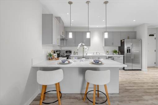 A modern kitchen with a dining table and chairs.
