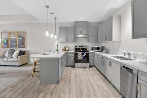 A modern kitchen with a large island and stainless steel appliances.