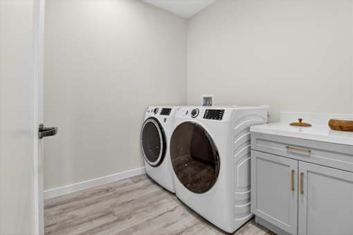 A washing machine and dryer in a laundry room.