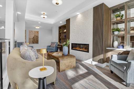 A modern living room with a fireplace and a large chair.