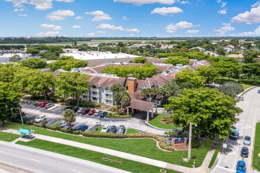 an aerial view of a neighborhood with cars parked in a parking lot