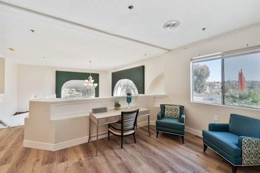A room with a reception desk and chairs.