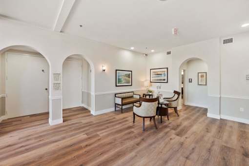 A room with arched doorways and a wooden floor.