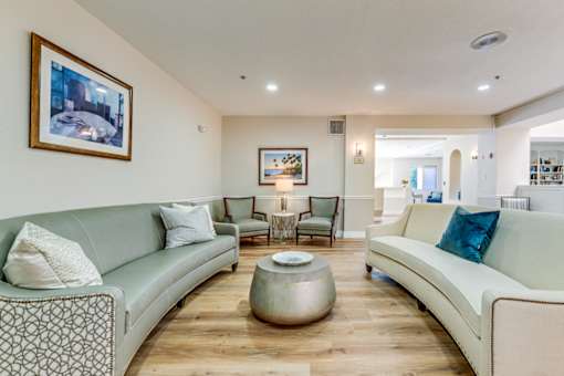 Living room with a grey couch at Azure Point at Encinitas - 55+ Active Adult Apartments, Encinitas, California