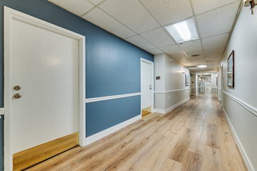 Long hallway at Azure Point at Encinitas - 55+ Active Adult Apartments, Encinitas, CA