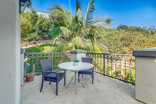 Balcony with a table and chairs at Azure Point at Encinitas - 55+ Active Adult Apartments, California