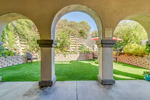 Patio with a stone archway at Azure Point at Encinitas - 55+ Active Adult Apartments, Encinitas