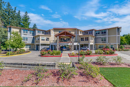 A modern apartment complex with a central courtyard and landscaping.