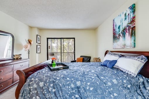 a bedroom with a bed and a dresser and a window