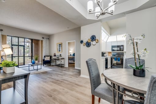 a living room and dining room with a table and chairs