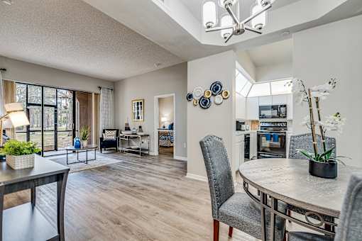 an open living room and dining room with a table and chairs