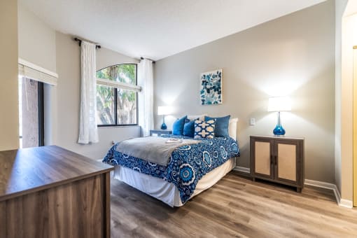 model bedroom with queen bed and furniture