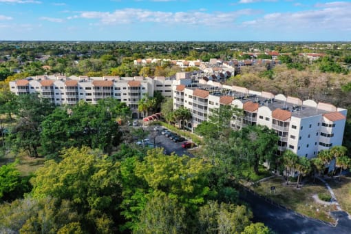 an aerial view of the community with trees and buildings