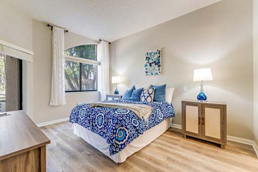 Bedroom with nightstand at Park Tower - 55+ Active Adult Apartments, Florida