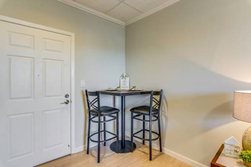 A small dining room with a table and two chairs.