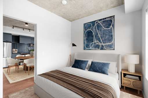 Suite 2502 - A bedroom with a large bed and a painting on the wall.