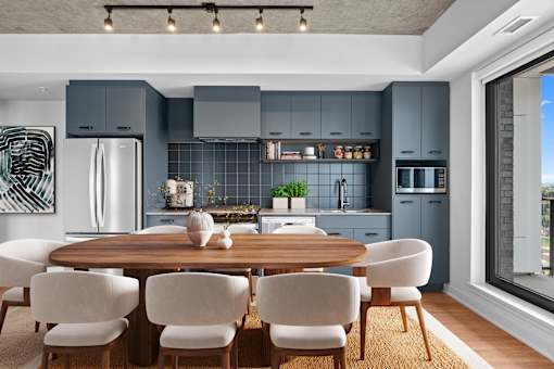 Suite 2502 - A modern kitchen with a dining table and chairs.