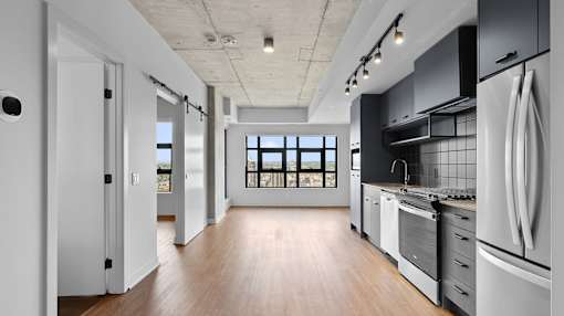 A modern kitchen with a large island and stainless steel appliances.