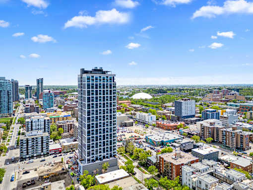 A cityscape with a tall building in the foreground and other buildings in the background.