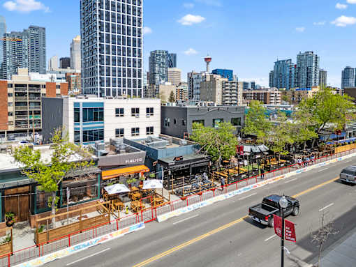 A city street with a truck parked on the side.