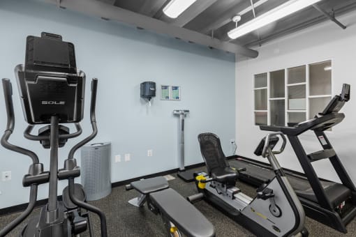 a gym with treadmills and other exercise equipment at the belgard apartments