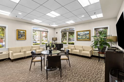 a conference room with couches and a table in the center of the room