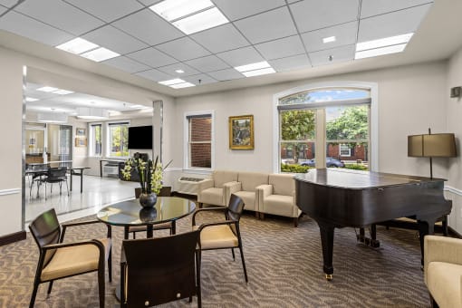 a lobby with a piano and a living room with couches