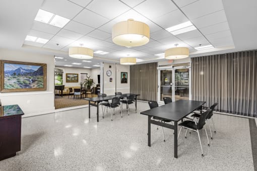 a conference room with tables and chairs in the center of it