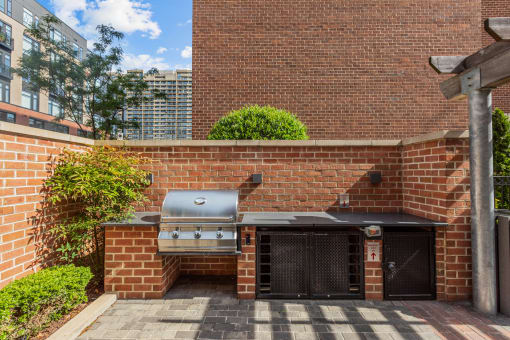 a barbecue grill on the side of a brick wall