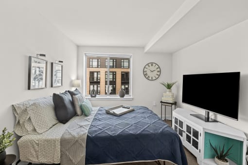 a bedroom with a large bed and a tv